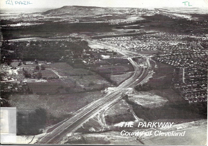 Front cover of a booklet with the title "The Parkway", showing a black and white aerial photograph of a dual carriageway being built between housing estates and fields