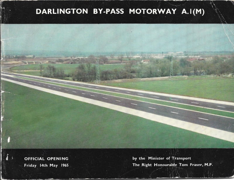 Front cover of a booklet with the title "Darlington By-Pass Motorway A1(M)", and a colour photograph of a new motorway passing in a straight line through green countryside
