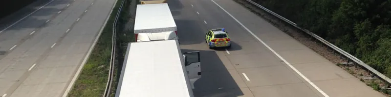 A police car drives the wrong way along the closed M20 during Operation Stack. Click to enlarge