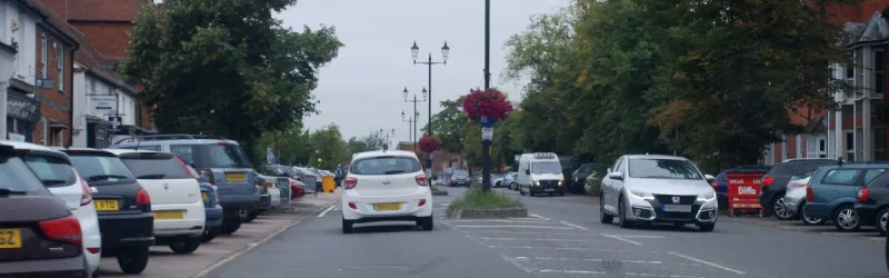 Through the centre of Beaconsfield, the town's main shopping street is no longer a major arterial road but it's still dominated by cars. Click to enlarge