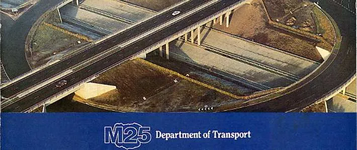 Front cover of a booklet with the title "The M25 Orbital Motorway" and a colour aerial photograph of the three level stacked roundabout interchange at Wisley