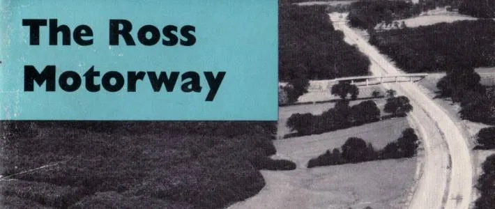 Black and white aerial photograph of a motorway curving through the countryside, with the words "The Ross Motorway" superimposed