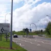 The next roundabout is not part of the New Town development; it was added in the late 1990s (along with these out-of-place traffic lights) to provide a new entrance to Birchwood Park, the enormous business estate just to the north. It has another meaningless sculpture in the middle.