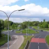 Seen from a footbridge just to the south, this is the junction it's approaching (from the previous photo traffic enters from the right). When originally built it had two three-lane roundabouts linked by a dual-carriageway, but more recently the redundant parts of the roundabouts have been filled in to make a single strangely-shaped one. Its unusual shape makes it a local accident blackspot.
