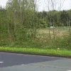 The distance between the carriageways as they meet the dumbbell roundabout is enormous - no shortage of space for a flyover.