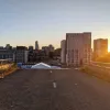 The setting sun makes for a dramatic view through the railings at the stub of the southern flyover. The opposite end isn't visible - the flyover snaked away between buildings to the left.