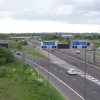 The next roadway the bridge crosses is the central pair of carriageways, which run from the M60 to the A666 into Bolton. Again, just west of the bridge, they split into separate sliproads, and the one on the left begins to descend gently to cross one of the sliproads in the previous picture. This crossover is the "braiding" that the name of the junction references.