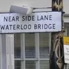 On the Strand, a sign telling people to get in lane by advising them where it goes. This sign was removed, about thirty years after the Waterloo Bridge lanes were physically separated and it became redundant.  Photo by Tony