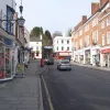 Looking north on the A217 in the town centre, a smaller hill rises in the middle of the built-up area, just behind the buildings ahead. This was the site of Reigate's castle, now long gone — the grounds of which stopped the London road from getting through.