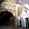 It seems to be less used than it used to be; buildings like the one on the right seem to be closed-up, and inside the tunnel, there's boarded-up openings to man-made caves where sand was extracted and the resulting space used to store beers and spirits.