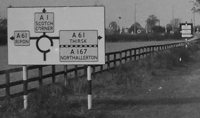 A sign on the A1 conforming to 1950s road sign regulations. Click to enlarge